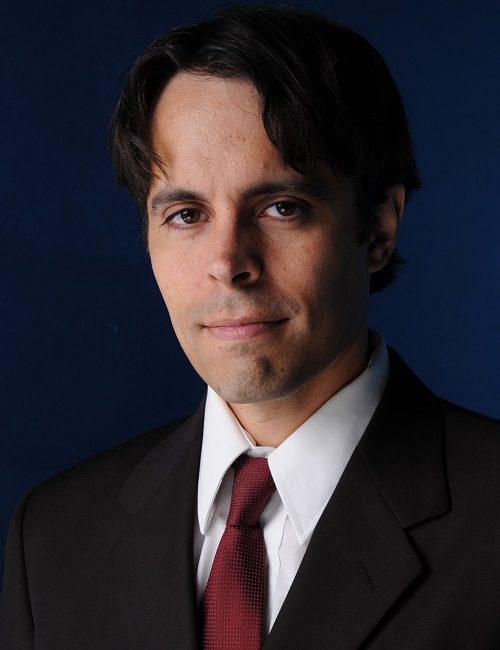 A man in suit and tie posing for the camera.